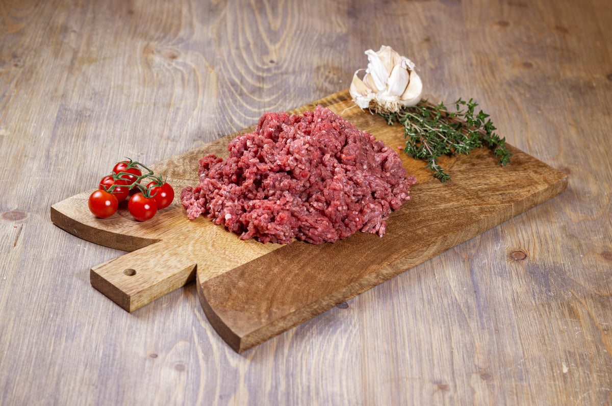 Minced Hereford beef on a wooden board
